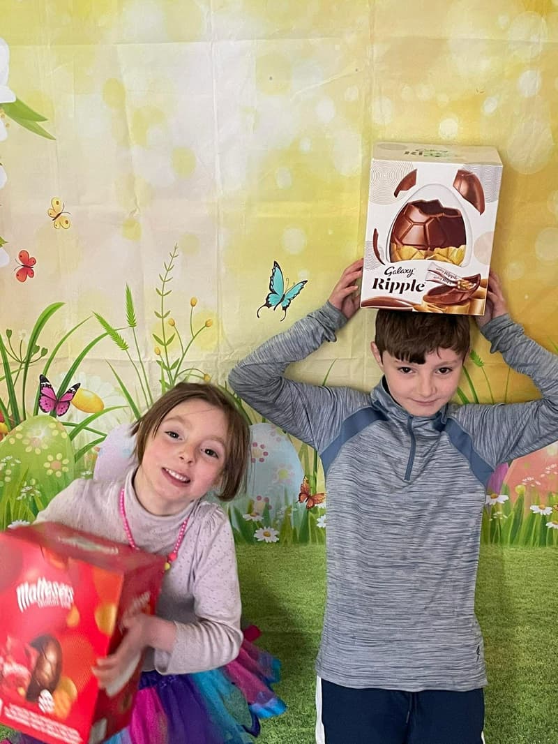 Children enjoying an Easter egg hunt on church grounds