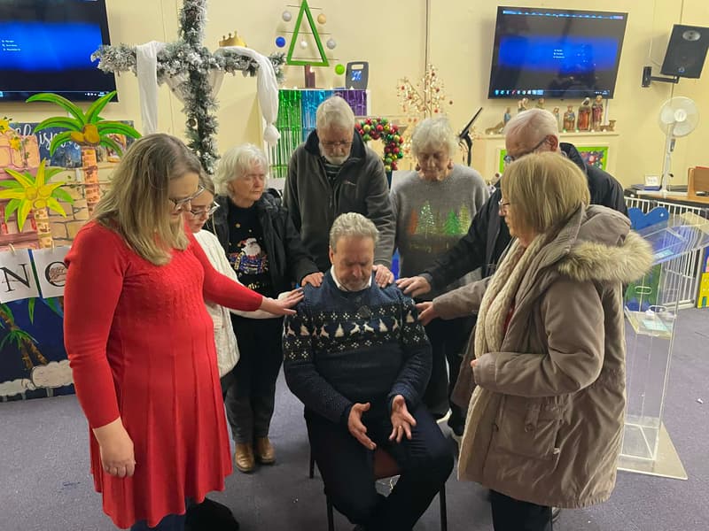 Church members praying together during a prayer meeting